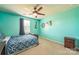 Bedroom with blue walls, carpet flooring, a ceiling fan and a bed with a blue comforter at 1012 Leland Dr, Wesley Chapel, NC 28104