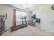 Exercise room with workout equipment, television, and a chandelier at 1012 Leland Dr, Wesley Chapel, NC 28104