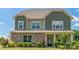 Charming two-story home features stone accents, a covered porch, and well-maintained landscaping at 1012 Leland Dr, Wesley Chapel, NC 28104