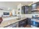 Well-equipped kitchen boasts granite countertops, stainless steel appliances, and dark wood cabinetry at 1012 Leland Dr, Wesley Chapel, NC 28104