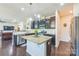 Modern kitchen features a center island, granite countertops, dark wood cabinets, and stainless steel appliances at 1012 Leland Dr, Wesley Chapel, NC 28104