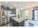 Modern kitchen features a center island with granite countertops and stainless steel appliances at 1012 Leland Dr, Wesley Chapel, NC 28104