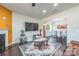Cozy living room features a fireplace, large TV, and seamless flow into the dining area at 1012 Leland Dr, Wesley Chapel, NC 28104