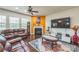Bright living room features a fireplace, large TV, and comfortable seating at 1012 Leland Dr, Wesley Chapel, NC 28104