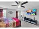 Spacious bedroom features a ceiling fan, desk and entertainment center with a mounted tv at 1012 Leland Dr, Wesley Chapel, NC 28104