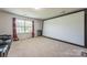 Finished theater room with a large projector screen, window, and leather reclining seats at 1012 Leland Dr, Wesley Chapel, NC 28104