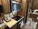 RV kitchen with cooktop, microwave, refrigerator, and coffee maker at 104 Cardinal Dr, New London, NC 28127