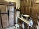 A kitchenette with wooden cabinets, white countertops and a small refrigerator at 104 Cardinal Dr, New London, NC 28127