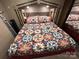 Main bedroom features colorful quilt bedding and overhead storage at 104 Cardinal Dr, New London, NC 28127