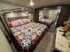 View of Main Bedroom featuring colorful quilt bedding, dresser and large mirror at 104 Cardinal Dr, New London, NC 28127