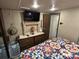 Image of the Main Bedroom featuring quilt bedding, TV and dresser at 104 Cardinal Dr, New London, NC 28127