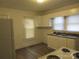 An efficient kitchen featuring white cabinets, laminate countertops, and an electric range at 1110 20Th Ne St, Hickory, NC 28601