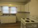 Efficient kitchen with ample white cabinetry, laminate countertops, and an electric range at 1110 20Th Ne St, Hickory, NC 28601