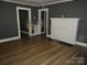 Living room featuring wood-look flooring, a fireplace, neutral gray walls, and white trim at 1110 20Th Ne St, Hickory, NC 28601
