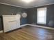 Inviting living room features wood-look flooring, a fireplace, a large window, and neutral gray walls at 1110 20Th Ne St, Hickory, NC 28601