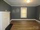 Living room featuring wood-look flooring, a fireplace, neutral gray walls, and white trim at 1110 20Th Ne St, Hickory, NC 28601