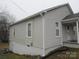 Side view of a light gray home with white trim, windows, and a partial basement at 1110 20Th Ne St, Hickory, NC 28601