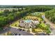 Aerial view of the community clubhouse featuring a pool, playground, and parking area at 11412 Preservation Ln, Charlotte, NC 28278