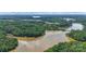 Breathtaking aerial view highlighting the community's location near a lake and lush surrounding nature at 11412 Preservation Ln, Charlotte, NC 28278
