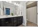 Elegant bathroom featuring double sinks, white countertop, and a shower at 11412 Preservation Ln, Charlotte, NC 28278