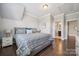 Comfortable bedroom with a large bed and hardwood floors, leading to an ensuite bathroom at 11412 Preservation Ln, Charlotte, NC 28278