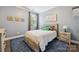 Cozy bedroom featuring a wooden bed frame, blue rug and dinosaur decor at 11412 Preservation Ln, Charlotte, NC 28278