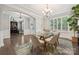 Elegant dining room with a glass table, modern chandelier and decorative rug at 11412 Preservation Ln, Charlotte, NC 28278