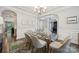 Elegant dining room with a glass table, modern chandelier and decorative rug at 11412 Preservation Ln, Charlotte, NC 28278