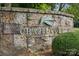 Stone entrance sign for Chapel Cove community, featuring botanical design elements at 11412 Preservation Ln, Charlotte, NC 28278