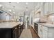 Spacious kitchen featuring an island with seating, modern appliances, and natural light at 11412 Preservation Ln, Charlotte, NC 28278