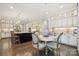 Bright kitchen with white cabinets, granite countertops, stainless appliances, and an adjacent breakfast nook at 11412 Preservation Ln, Charlotte, NC 28278