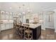 Spacious kitchen features a large center island with seating, pendant lights, and stainless steel appliances at 11412 Preservation Ln, Charlotte, NC 28278