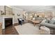 Open-concept living room with a fireplace, plush seating, and seamless access to the kitchen at 11412 Preservation Ln, Charlotte, NC 28278