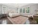 Serene primary bedroom with large windows, plantation shutters, a chandelier, and stylish decor at 11412 Preservation Ln, Charlotte, NC 28278