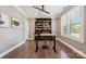 Home office with a ceiling fan, built-in shelving, wood floors and natural light at 11412 Preservation Ln, Charlotte, NC 28278
