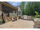 Outdoor patio with a full kitchen including grill, bar, and seating area next to a screened in porch at 11412 Preservation Ln, Charlotte, NC 28278