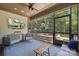 Relaxing screened porch with comfortable seating, outdoor view, and ceiling fan at 11412 Preservation Ln, Charlotte, NC 28278