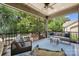 Spacious screened porch featuring cozy seating, overhead lighting, and beautiful backyard views at 11412 Preservation Ln, Charlotte, NC 28278