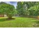 Picturesque backyard showcases a mature tree, and wood fence, enhancing the property's charm and appeal at 11539 Five Cedars Rd, Charlotte, NC 28226