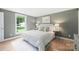 Bright bedroom features a plush bed, fresh neutral paint, and a large window that fills the space with natural light at 11539 Five Cedars Rd, Charlotte, NC 28226