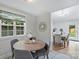 Cozy dining area with bright window, stylish decor, and tile flooring at 11539 Five Cedars Rd, Charlotte, NC 28226