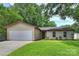 Charming single-story home with a well-maintained lawn and attached two-car garage at 11539 Five Cedars Rd, Charlotte, NC 28226