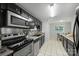 Updated kitchen boasts stainless steel appliances, modern backsplash, and ample cabinet space with breakfast nook in background at 11539 Five Cedars Rd, Charlotte, NC 28226