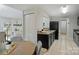 A view of the kitchen looking past the eat-in breakfast area and showing modern appliances at 11539 Five Cedars Rd, Charlotte, NC 28226