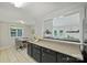 Open-concept kitchen with black cabinets and eat-in breakfast nook, offering a seamless flow to living spaces at 11539 Five Cedars Rd, Charlotte, NC 28226