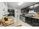 This modern kitchen features black cabinets, stainless steel appliances and mosaic backsplash at 11539 Five Cedars Rd, Charlotte, NC 28226