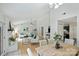 Open concept living room and dining area with neutral furniture, fireplace, and kitchen passthrough at 11539 Five Cedars Rd, Charlotte, NC 28226