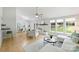 Bright living room with white brick fireplace, hardwood floors, and large windows at 11539 Five Cedars Rd, Charlotte, NC 28226