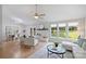 Bright living room featuring a fireplace, ceiling fan, and views of the backyard at 11539 Five Cedars Rd, Charlotte, NC 28226