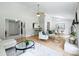 Open-concept living room with a fireplace, bar seating, and connected dining area at 11539 Five Cedars Rd, Charlotte, NC 28226